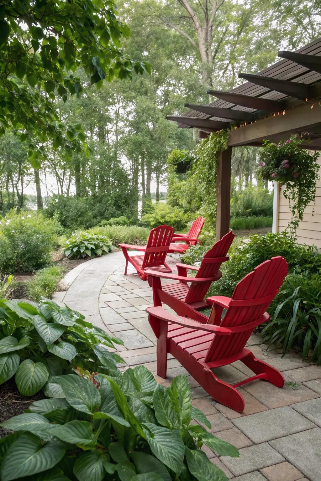 Red Adirondack chairs stand out against a backdrop of greenery.