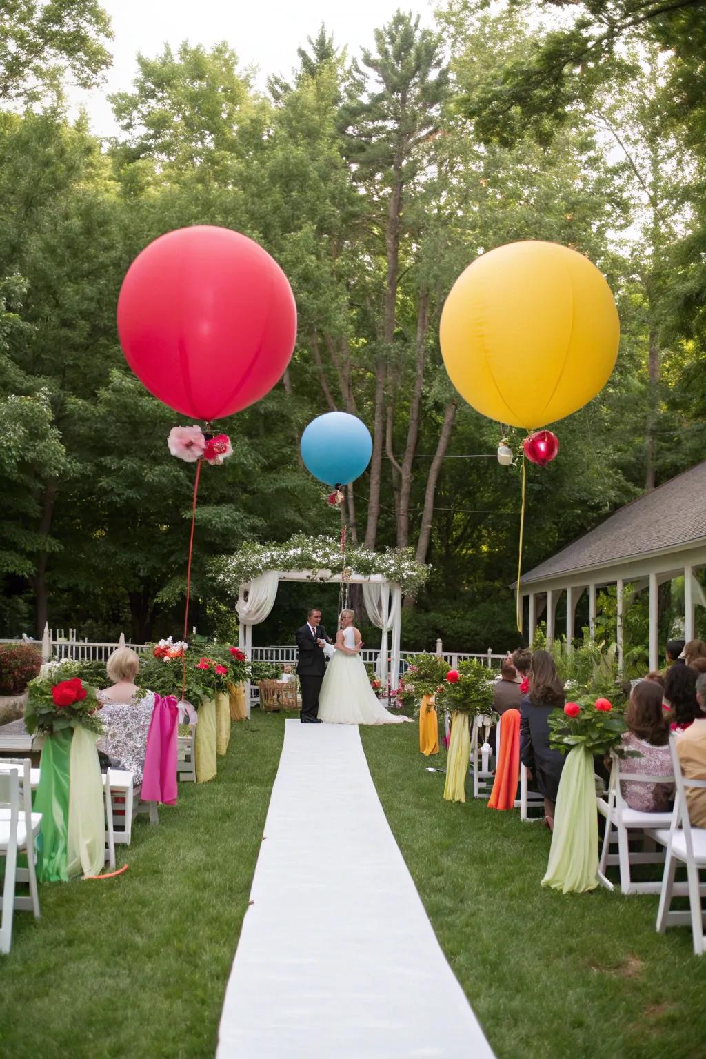 A garden wedding decorated with giant rainbow-colored balloons.