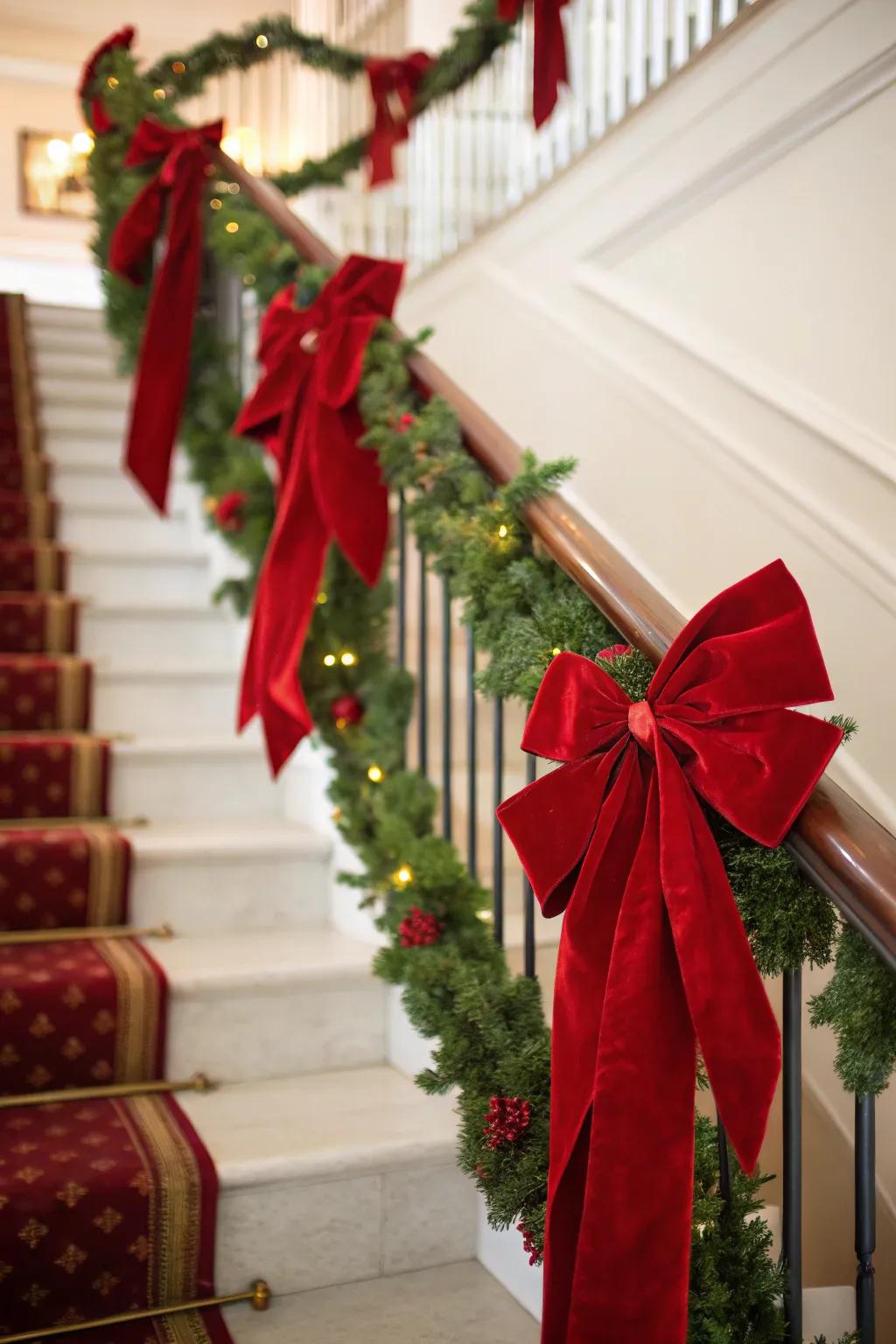 Staircase decorated with red velvet bows and ribbons.