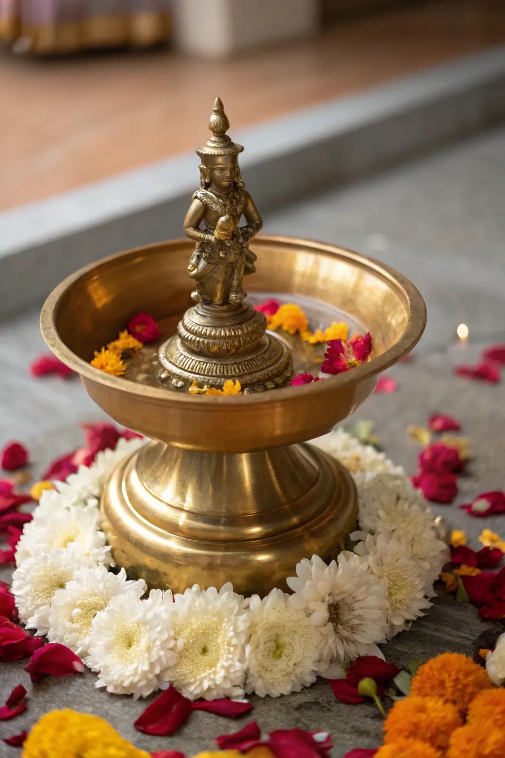 A traditional deity centerpiece enhances your <strong>uruli</strong>‘s soul, resonating with peace and reverence.” loading=”lazy” class=”pimg”>
	</picture><figcaption>A traditional deity centerpiece enhances your <strong>uruli</strong>‘s soul, resonating with peace and reverence.</figcaption></figure>
<p>Invite a small deity to reside at the heart of your <strong>uruli</strong>, bestowing a sense of the sacred upon your space. Encircle it with tender flower petals or soft moss, adding layers of depth and divine beauty.</p>
<h3>Some ideas to consider:</h3>
<ul class=