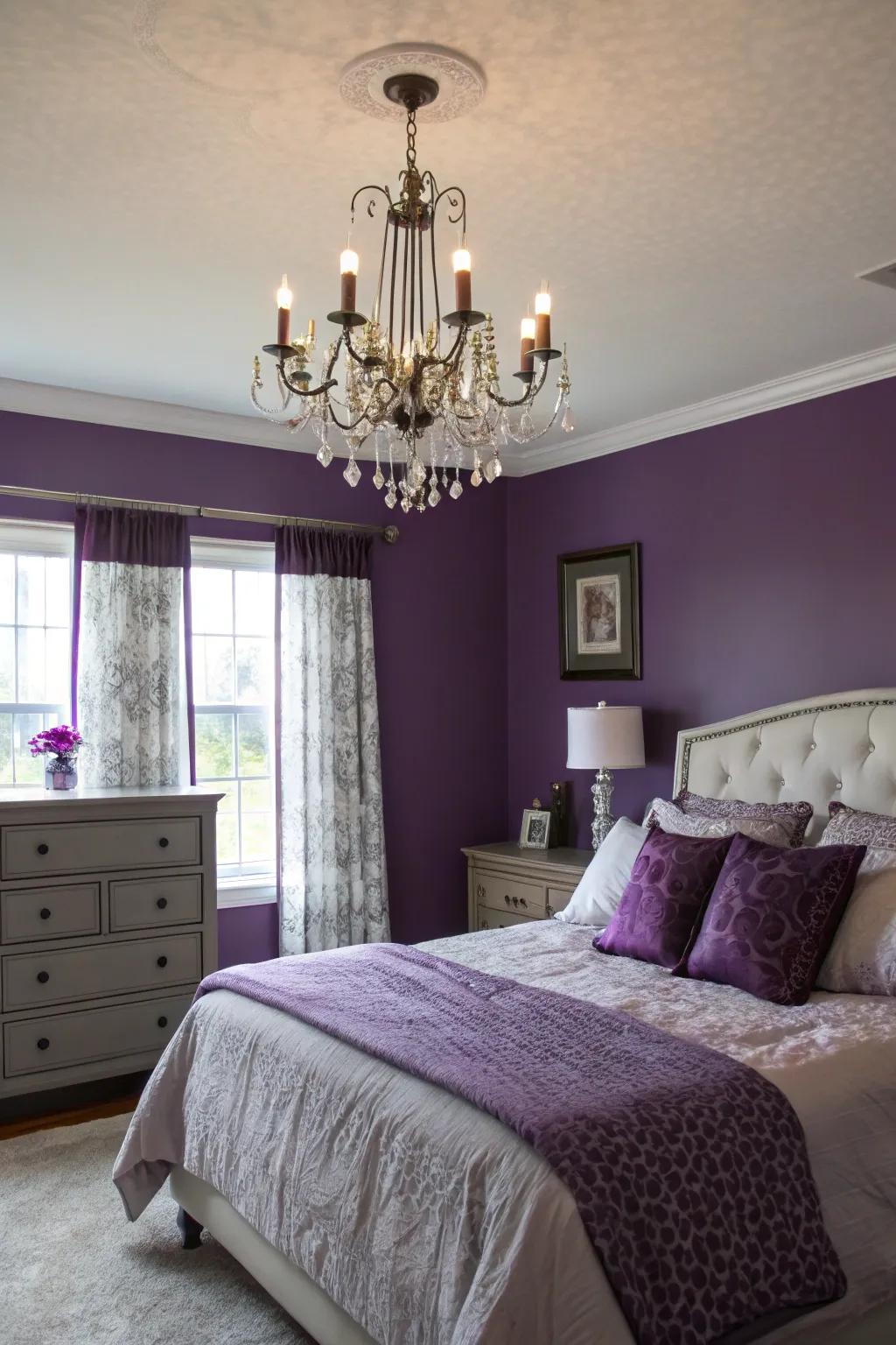 A statement chandelier illuminating violet walls elegantly.