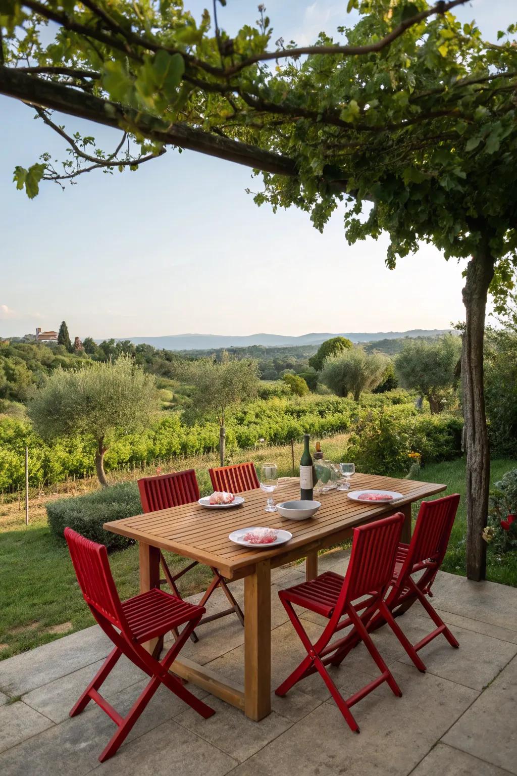 Red dining chairs add energy to the outdoor dining area.