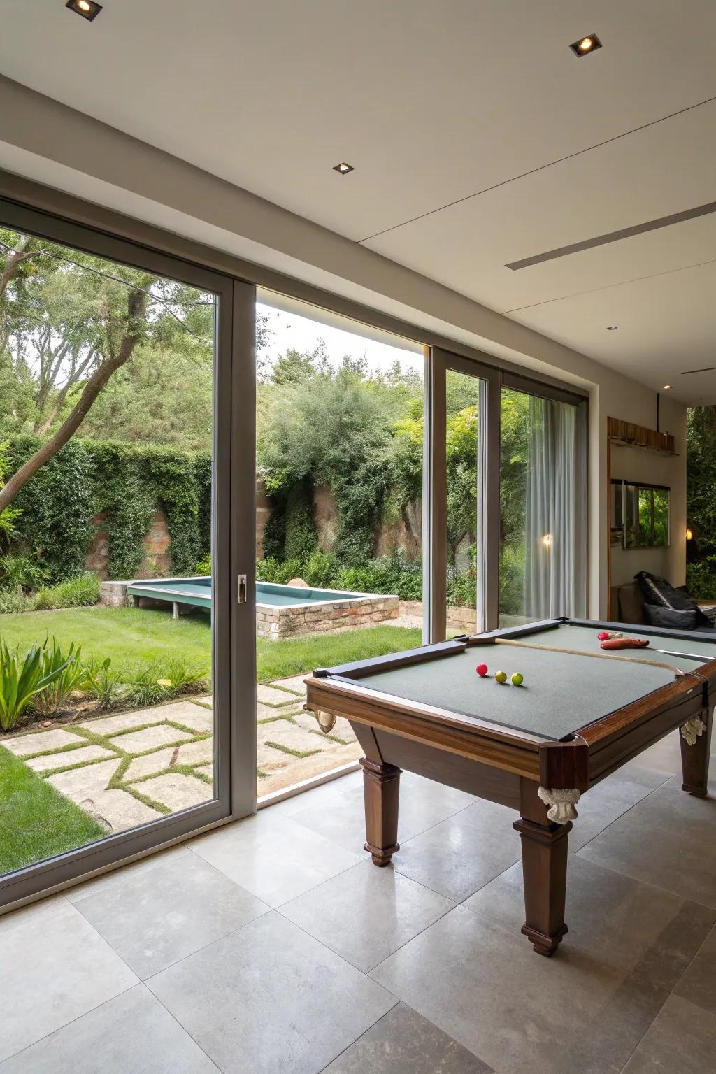 An indoor-outdoor living area with a pool table and garden access.